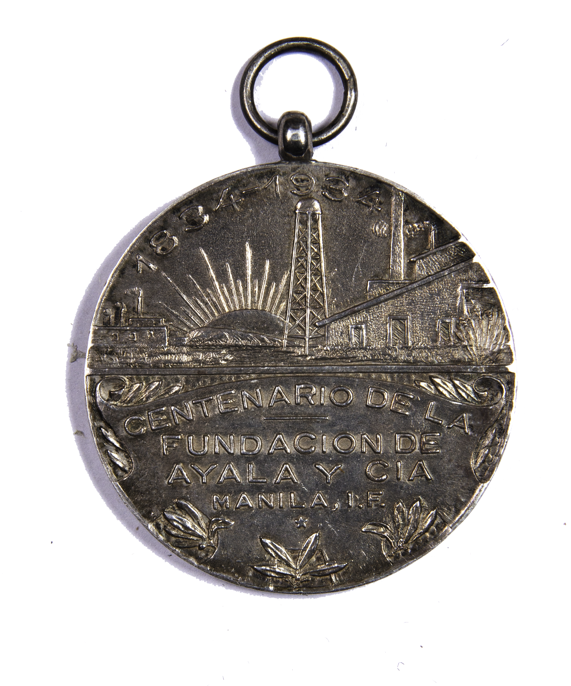 The commemorative medallion bears the inscription: “1834-1934 / Centenario de la Fundación de Ayala y Cía / Manila, I.F. [Islas Filipinas]”.