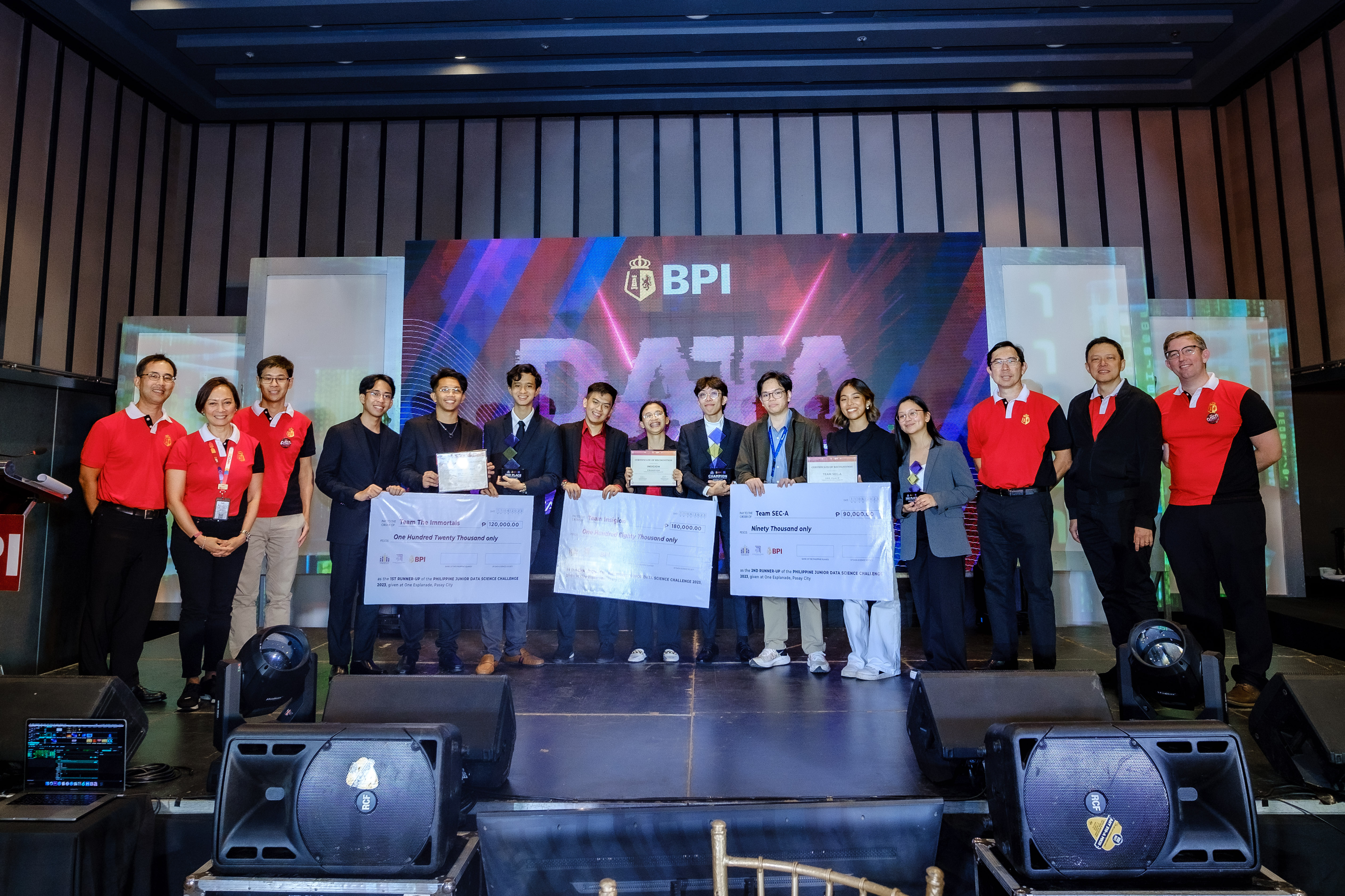 The winning hackathon teams with (from left) BPI CFO and Chief Sustainability Officer Eric Luchangco and Chief HR Officer Gina Eala, BPI Board Director and Ayala Corporation Managing Director for Data Science and AI Karl Kendrick Chua, and BPI President and CEO TG Limcaoco, Business Transformation and Data Analytics Group Head Joaquin Abola, and Analytics Head Nicholas Huber